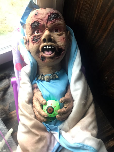 Zombie baby plays with eyeballs